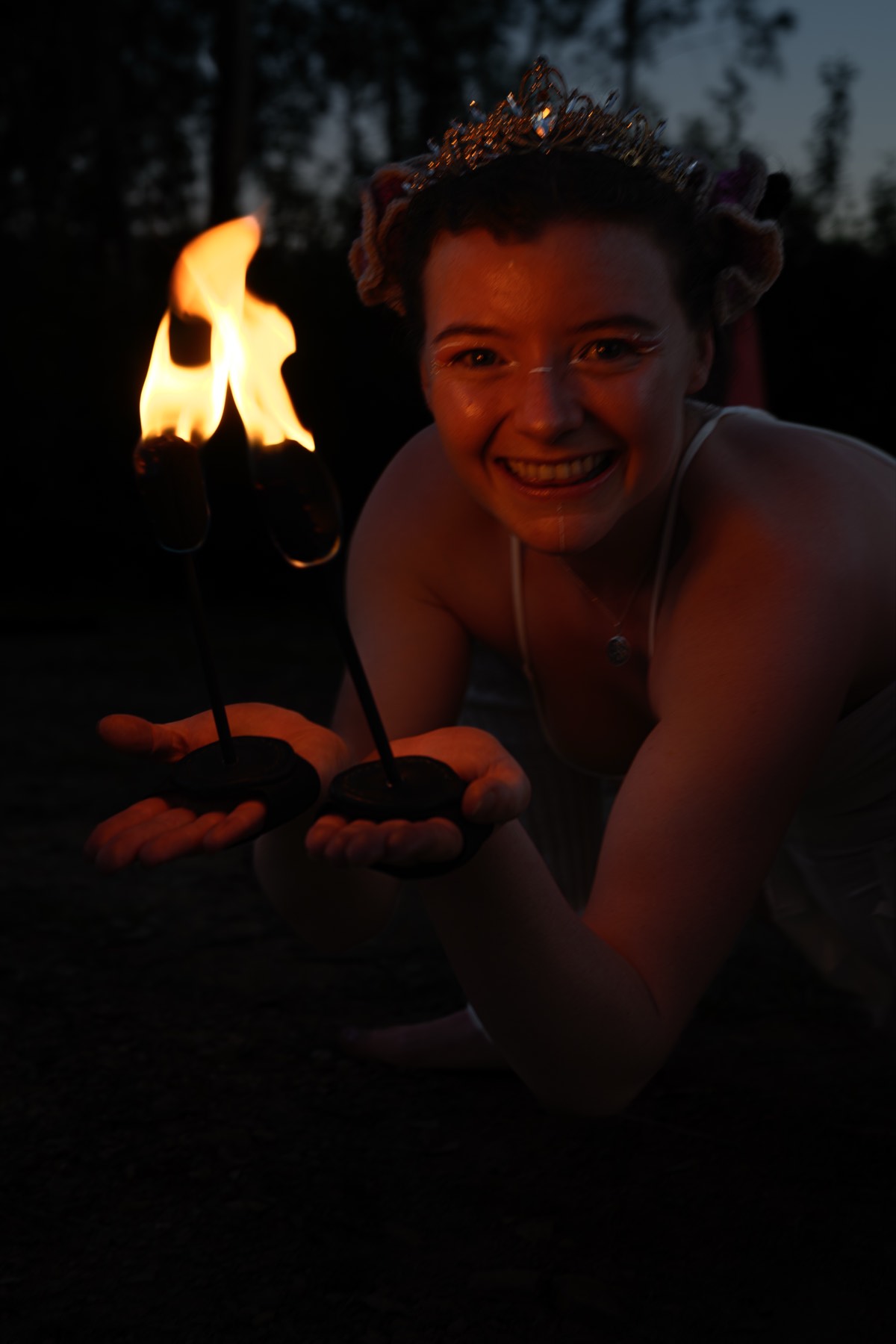 Two fire fans, held carefully.