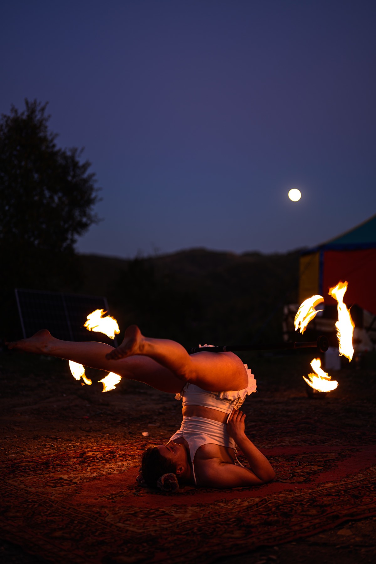 Fire spinning under a full moon.