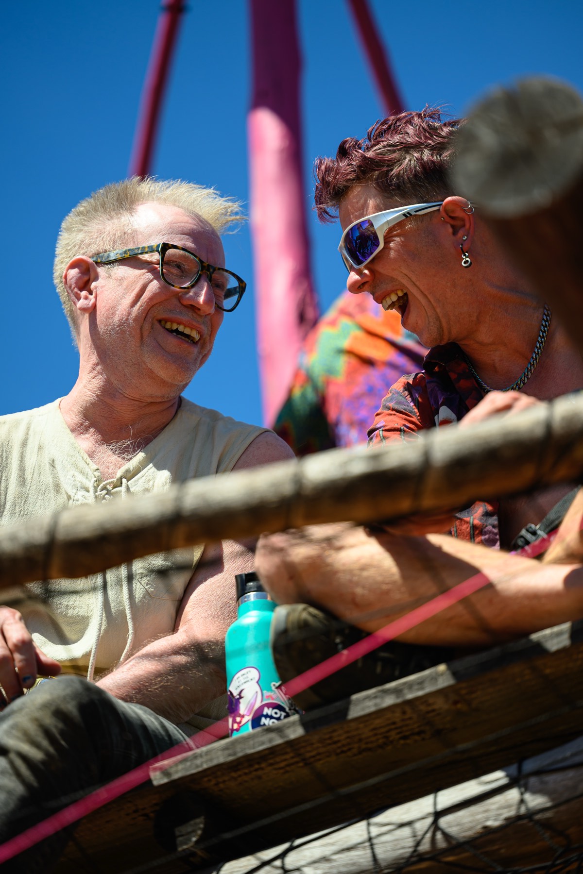 Two people laughing on the rig.
